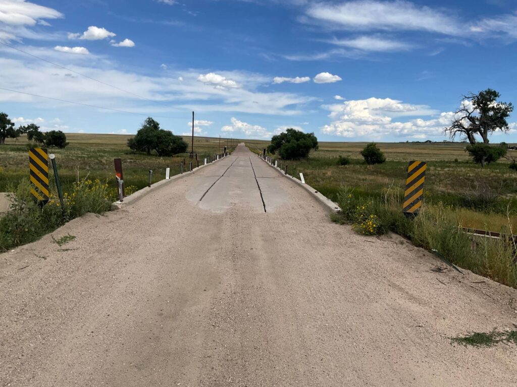 Aging concrete bridge on a gravel county road in rural Elbert County